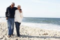 Senior Couple Walking Along Beach Together Royalty Free Stock Photo