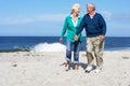 Senior Couple Walking Along Beach Together Royalty Free Stock Photo