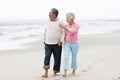 Senior Couple Walking Along Beach Together Royalty Free Stock Photo