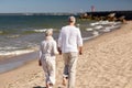 Senior couple walking along summer beach Royalty Free Stock Photo