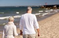 Senior couple walking along summer beach Royalty Free Stock Photo