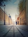 Senior couple walking outdoors together. Healthy lifestyle, elder love concept. Happy old pair strolling on the town alley in