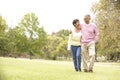 Senior Couple Walking In Park Royalty Free Stock Photo