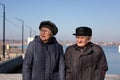 Senior couple walking on a promenade on a winter day