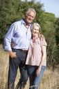 Senior Couple Walking Through Summer Countryside Royalty Free Stock Photo