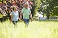 Senior Couple Walking In Summer Countryside