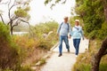 Senior couple walking together on a path by a lake Royalty Free Stock Photo