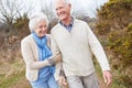 Senior Couple Walking Through Winter Countryside