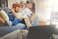 Senior couple watching a movie on sofa with laptop in the living room together for bonding. Happy, smile and elderly man Royalty Free Stock Photo