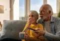 Mature couple watching scary movie at home Royalty Free Stock Photo