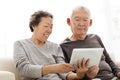 Senior Couple watching the tablet on sofa Royalty Free Stock Photo