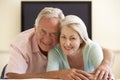 Senior Couple Watching Widescreen TV At Home Royalty Free Stock Photo