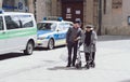 A senior couple wearing face masks walks through downtown Munich
