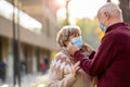 Senior couple wearing protective face masks outdoors