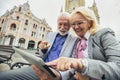 Senior couple websurfing on internet with tablet outdoor Royalty Free Stock Photo