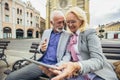 Senior couple websurfing on internet with tablet outdoor Royalty Free Stock Photo