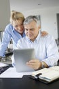 Senior couple websurfing on tablet Royalty Free Stock Photo