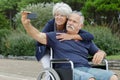 senior couple in wheelchairs doing selfie Royalty Free Stock Photo