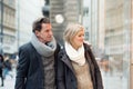 Senior couple window shopping in city centre. Winter Royalty Free Stock Photo