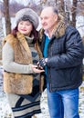 Christmas Holidays, woman and senior man walk at park Royalty Free Stock Photo