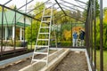 Senior couple working on a project in their garden. Man and woman constructing a greenhouse in their backyard Royalty Free Stock Photo