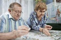 Senior couple working on a puzzle Royalty Free Stock Photo