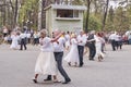 Senior couples dance in park.