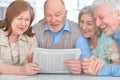 Senior couples reading newspaper Royalty Free Stock Photo