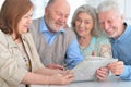 senior couples reading newspaper Royalty Free Stock Photo