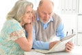 Senior couples reading newspaper Royalty Free Stock Photo