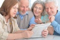 Senior couples reading newspaper Royalty Free Stock Photo