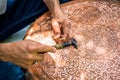 Senior craftsman working with decoration pattern on metal plate Royalty Free Stock Photo