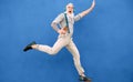 Senior crazy man jumping while listening music with wireless headphones - Hipster old guy having fun dancing outdoor Royalty Free Stock Photo