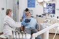 Senior dentist woman with face mask explaining teeth radiography Royalty Free Stock Photo