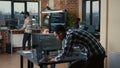 Senior developer coding on laptop at desk with computer screens parsing code