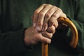 Senior disabled man clasping his walking stick