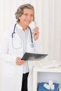 Senior doctor female hold x-ray and phone Royalty Free Stock Photo