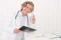 Senior doctor female hold x-ray and phone Royalty Free Stock Photo