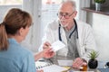 Senior doctor giving prescription to his patient Royalty Free Stock Photo