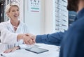 Senior doctor, handshake or man consulting for eyesight advice at optometrist or ophthalmologist with medical aid. Happy Royalty Free Stock Photo