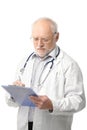 Senior doctor looking at clipboard