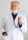 Senior doctor male showing stethoscope for listening heart rate at hospital,Selective focus hands