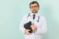 Senior doctor man wearing stethoscope and medical coat oveer blue background Royalty Free Stock Photo