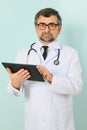 Senior doctor man wearing stethoscope and medical coat oveer blue background Royalty Free Stock Photo