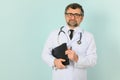 Senior doctor man wearing stethoscope and medical coat oveer blue background Royalty Free Stock Photo