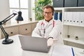 Senior doctor man working on online appointment smiling cheerful offering palm hand giving assistance and acceptance Royalty Free Stock Photo