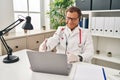 Senior doctor man working on online appointment smiling friendly offering handshake as greeting and welcoming Royalty Free Stock Photo