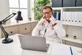 Senior doctor man working on online appointment smiling with open mouth, fingers pointing and forcing cheerful smile Royalty Free Stock Photo