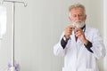 Senior doctor men prepare giving vaccine with injection or syringe to scared patient at hospital Royalty Free Stock Photo