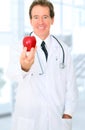 Senior Doctor Offering Red Apple To Patient Royalty Free Stock Photo